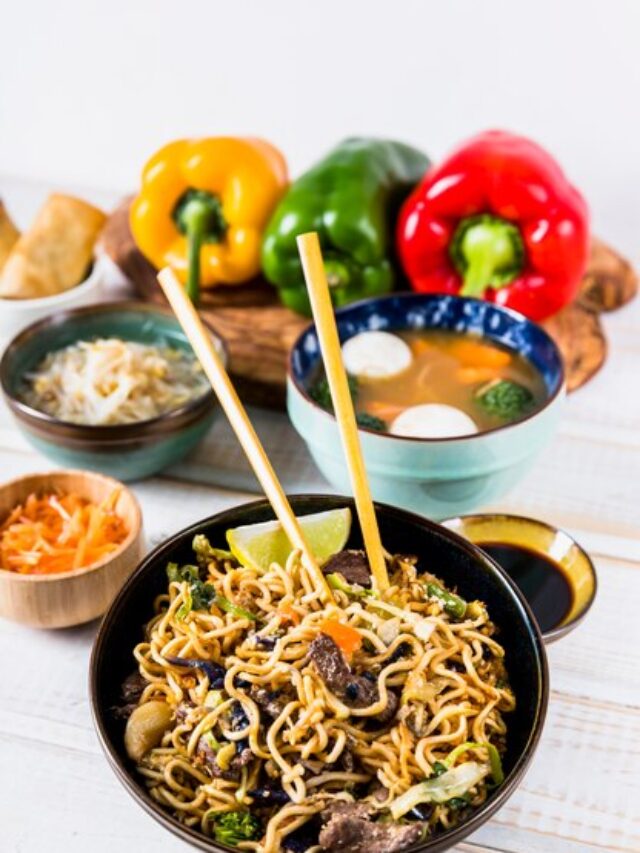 delicious-stir-fry-noodles-with-beef-chopsticks-with-soup-bowl-wooden-desk_23-2148093356