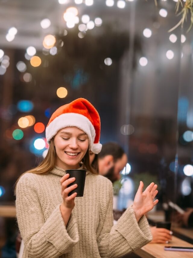 girl-wearing-santa-claus-hat-sitting-coffee-shop-drinking-coffee_1153-7440