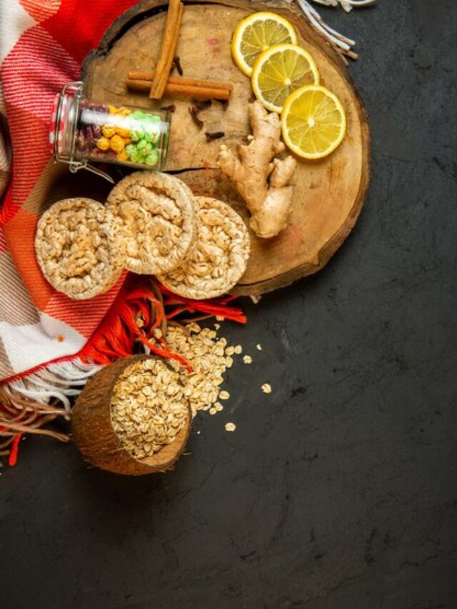 top-view-composition-with-corn-diet-bread-candies-cinnamon-sticks-lemon-slices-ginger-wooden-board-black_140725-12542